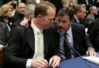 WASHINGTON - MARCH 17:  Former St. Louis Cardinal Mark McGwire (L) talks with Rafael Palmeiro of the Baltimore Orioles during a House Committe session investigating Major League Baseball's effort to eradicate steroid use on Capital Hill March 17, 2005 in Washington, DC. McGwire and Palmeiro were named in the Mitchell Report that was released December 13, 2007 by a committee looking into use of performance-enhancing drugs in Major League Baseball and headed by former Senate Majority Leader George Mitchell.  (Photo by Mark Wilson/Getty Images)