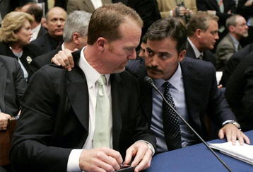 WASHINGTON - MARCH 17:  Former St. Louis Cardinal Mark McGwire (L) talks with Rafael Palmeiro of the Baltimore Orioles during a House Committe session investigating Major League Baseball's effort to eradicate steroid use on Capital Hill March 17, 2005 in Washington, DC. McGwire and Palmeiro were named in the Mitchell Report that was released December 13, 2007 by a committee looking into use of performance-enhancing drugs in Major League Baseball and headed by former Senate Majority Leader George Mitchell.  (Photo by Mark Wilson/Getty Images)