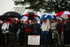 FARMINGDALE, NY - JUNE 18:  Fans watch the first tee ball of the championship in the rain during the first round of the 109th U.S. Open on the Black Course at Bethpage State Park on June 18, 2009 in Farmingdale, New York.  (Photo by Nick Laham/Getty Images)