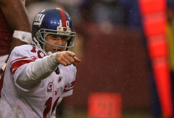 LANDOVER, MD - NOVEMBER 30:  Eli Manning #10 of the New York Giants runs points to his team against the Washington Redskins during their game at FedEx Field on November 30, 2008 in Landover, Maryland.  (Photo by Streeter Lecka/Getty Images)