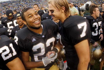 SOUTH BEND, IN - SEPTEMBER 13:  Golden Tate #23 of the Notre Dame Fighting Irish celebrates with Jimmy Clausen #7 after a 35-17 victory over the Michigan Wolverines on September 13, 2008 at Notre Dame Stadium in South Bend, Indiana.  (Photo by Gregory Shamus/Getty Images)