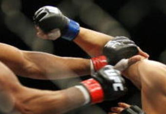 CHICAGO- OCTOBER 25:  Anderson Silva (L) punches Patrick Cote in the Middleweight Title Bout at UFC's Ultimate Fight Night at Allstate Arena on October 25, 2008 in Chicago, Illinois. (Photo by Tasos Katopodis/Getty Images)