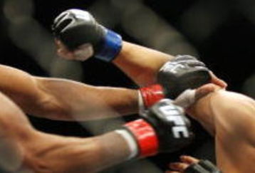 CHICAGO- OCTOBER 25:  Anderson Silva (L) punches Patrick Cote in the Middleweight Title Bout at UFC's Ultimate Fight Night at Allstate Arena on October 25, 2008 in Chicago, Illinois. (Photo by Tasos Katopodis/Getty Images)