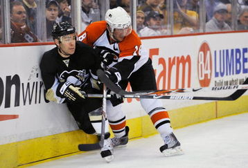 PITTSBURGH - APRIL 15:  Forward Pascal Dupuis #9 of the Pittsburgh Penguins is checked by forward Mike Richards #18 of the Philadelphia Flyers during game one of the 2009 Eastern Conference quarterfinals at Mellon Arena on April 15, 2009 in Pittsburgh, Pennsylvania.  (Photo by Jamie Sabau/Getty Images)