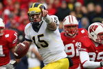MADISON, WI - NOVEMBER 10: Ryan Mallett #15 of the Michigan Wolverines runs out of the pocket to throw a pass against the Wisconsin Badgers on November 10, 2007 at Camp Randall Stadium in Madison, Wisconsin. Wisconsin defeated Michigan 37-21. (Photo by Jonathan Daniel/Getty Images)
