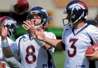 ENGLEWOOD, CO - MAY 03:  Quarterback Kyle Orton #8 has the ball jokingly tipped form his hands by  sixth round draft pick rookie quarterback Tom Brandslater #3 during Denver Broncos Minicamp at the Broncos training facility on May 3, 2009 in Englewood, Colorado.  (Photo by Doug Pensinger/Getty Images)