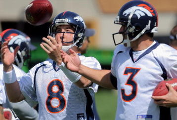 ENGLEWOOD, CO - MAY 03:  Quarterback Kyle Orton #8 has the ball jokingly tipped form his hands by  sixth round draft pick rookie quarterback Tom Brandslater #3 during Denver Broncos Minicamp at the Broncos training facility on May 3, 2009 in Englewood, Colorado.  (Photo by Doug Pensinger/Getty Images)