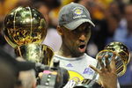 ORLANDO, FL - JUNE 14:  Kobe Bryant #24 of the Los Angeles Lakers holds the Bill Russell MVP trophy and the Larry O'Brien trophy after defeating the Orlando Magic in Game Five of the 2009 NBA Finals on June 14, 2009 at Amway Arena in Orlando, Florida. The Lakers won 99-86.  NOTE TO USER:  User expressly acknowledges and agrees that, by downloading and or using this photograph, User is consenting to the terms and conditions of the Getty Images License Agreement. (Photo by Ronald Martinez/Getty Images) 