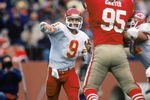 SAN FRANCISCO - NOVEMBER 17:  Quarterback Bill Kenney #9 of the Kansas City Chiefs attempts to pass over defensive linemen Michael Carter #95 of the San Francisco 49ers during a game at Candlestick Park on November 17, 1985 in San Francisco, California.  The 49ers won 31-3.  (Photo by George Rose/Getty Images)