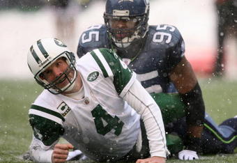 SEATTLE - DECEMBER 21:  Quarterback Brett Favre #4 of the New York Jets looks up after being tackled by Lawrence Jackson #95 of the Seattle Seahawks on December 21, 2008 at Qwest Field in Seattle, Washington. The Seahawks defeated the Jets 13-3. (Photo by Otto Greule Jr/Getty Images)
