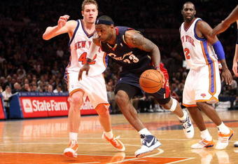NEW YORK - FEBRUARY 04:  LeBron James #23 of the Cleveland Cavaliers drives to the basket past David Lee #42 of the New York Knicks on February 4, 2009 at Madison Square Garden in New York City. NOTE TO USER: User expressly acknowledges and agrees that, by downloading and or using this photograph, User is consenting to the terms and conditions of the Getty Images License Agreement.  (Photo by Nick Laham/Getty Images)