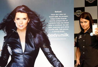 INDIANAPOLIS - MAY 07:  Danica Patrick driver of the #7 Motorola Andretti Green Racing Dallara Honda poses with some milk beside her new 'Got Milk?' ad campaign poster before practice for the IRL IndyCar Series 93rd running of the Indianapolis 500 on May 7, 2009 at Indianapolis Motor Speedway in Indianapolis, indiana.  (Photo by Jonathan Ferrey/Getty Images)