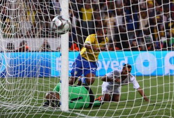 PRETORIA, SOUTH AFRICA - JUNE 18:  Maicon of Brazil chips the ball over Tim Howard of USA to score the 3rd goal during the FIFA Confederations Cup match between USA and Brasil at Loftus Versfeld Stadium on June 18, 2009 in Pretoria, South Africa.  (Photo by Jamie McDonald/Getty Images)