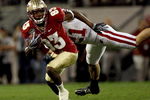 ORLANDO, FL - DECEMBER 27:  Bert Reed #83 of the Florida State Seminoles breaks the tackle of Chris Maragos #21 of the Wisconsin Badgers during the Champs Bowl on December 27, 2008 at the Citrus Bowl in Orlando, Florida.  (Photo by Sam Greenwood/Getty Images)