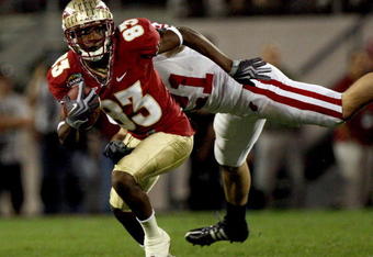 ORLANDO, FL - DECEMBER 27:  Bert Reed #83 of the Florida State Seminoles breaks the tackle of Chris Maragos #21 of the Wisconsin Badgers during the Champs Bowl on December 27, 2008 at the Citrus Bowl in Orlando, Florida.  (Photo by Sam Greenwood/Getty Images)