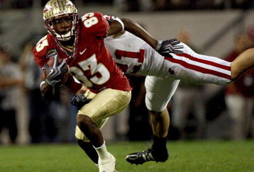 ORLANDO, FL - DECEMBER 27:  Bert Reed #83 of the Florida State Seminoles breaks the tackle of Chris Maragos #21 of the Wisconsin Badgers during the Champs Bowl on December 27, 2008 at the Citrus Bowl in Orlando, Florida.  (Photo by Sam Greenwood/Getty Images)