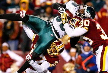 LANDOVER, MD - DECEMBER 21:  Receiver Reggie Brown #86 of the Philadelphia Eagles is stopped just short of the end zone by Fred Smoot #27 and LaRon Landry #30 of the Washington Redskins during the game on December 21, 2008 at FedEx Field in Landover, Maryland.  (Photo by Kevin C. Cox/Getty Images)