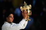 LONDON - JULY 06:  Rafael Nadal of Spain celebrates with the Championship trophy after winning the men's singles Final match against Roger Federer of Switzerland on day thirteen of the Wimbledon Lawn Tennis Championships at the All England Lawn Tennis and Croquet Club on July 6, 2008 in London, England.  (Photo by Lewis Whyld-Pool/Getty Images)