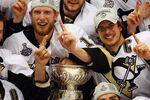 DETROIT - JUNE 12:  The Pittsburgh Penguins celebrate with the Stanley Cup after defeating the Detroit Red Wings by a score of 2-1 to win Game Seven and the 2009 NHL Stanley Cup Finals at Joe Louis Arena on June 12, 2009 in Detroit, Michigan.  (Photo by Jim McIsaac/Getty Images)