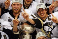 DETROIT - JUNE 12: The Pittsburgh Penguins celebrate with the Stanley Cup after defeating the Detroit Red Wings by a score of 2-1 to win Game Seven and the 2009 NHL Stanley Cup Finals at Joe Louis Arena on June 12, 2009 in Detroit, Michigan. (Photo by Jim McIsaac/Getty Images)