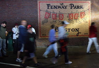 BOSTON - SEPTEMBER 27:  Fans leave the stadium after the the Boston Red Sox versus the New York Yankees was postponed due to rain on September 27, 2008 at Fenway Park in Boston, Massachusetts.  (Photo by Elsa/Getty Images)