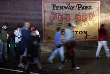 BOSTON - SEPTEMBER 27:  Fans leave the stadium after the the Boston Red Sox versus the New York Yankees was postponed due to rain on September 27, 2008 at Fenway Park in Boston, Massachusetts.  (Photo by Elsa/Getty Images)