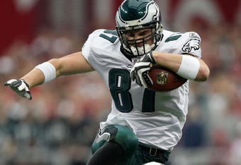 GLENDALE, AZ - JANUARY 18:  Tight end Brent Celek #87 of the Philadelphia Eagles jumps over cornerback Ralph Brown #20 of the Arizona Cardinals in the second quarter of the NFC championship game on January 18, 2009 at University of Phoenix Stadium in Glendale, Arizona.  (Photo by Jed Jacobsohn/Getty Images)