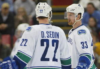 DETROIT - JANUARY 17:  The Sedin brothers Daniel #22 and Henrik #33 of the Vancouver Canucks chat prior to a faceoff in a game against the Detroit Red Wings on January 17, 2008 at the Joe Louis Arena in Detroit, Michigan. The Wings defeated the Canucks 3-2 in a shootout. (Photo by Claus Andersen/Getty Images)