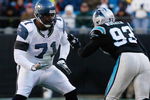 CHARLOTTE, NC - DECEMBER 16:  Walter Jones #71 of the Seattle Seahawks attempts to block Mike Rucker #93 of the Carolina Panthers during the second half at Bank of America Stadium on December 16, 2007 in Charlotte, North Carolina.  Carolina defeated Seattle 13-10.  (Photo by Kevin C. Cox/Getty Images)