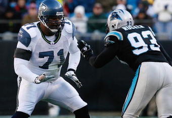 CHARLOTTE, NC - DECEMBER 16:  Walter Jones #71 of the Seattle Seahawks attempts to block Mike Rucker #93 of the Carolina Panthers during the second half at Bank of America Stadium on December 16, 2007 in Charlotte, North Carolina.  Carolina defeated Seattle 13-10.  (Photo by Kevin C. Cox/Getty Images)