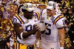 NEW ORLEANS - JANUARY 07:  Ricky Jean-Francois #90 and Matt Flynn #15 of the Louisiana State University Tigers celebrate with the championship trophy after defeating the Ohio State Buckeyes 38-24 in the AllState BCS National Championship on January 7, 2008 at the Louisiana Superdome in New Orleans, Louisiana.  (Photo by Christian Petersen/Getty Images)