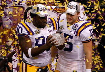 NEW ORLEANS - JANUARY 07:  Ricky Jean-Francois #90 and Matt Flynn #15 of the Louisiana State University Tigers celebrate with the championship trophy after defeating the Ohio State Buckeyes 38-24 in the AllState BCS National Championship on January 7, 2008 at the Louisiana Superdome in New Orleans, Louisiana.  (Photo by Christian Petersen/Getty Images)