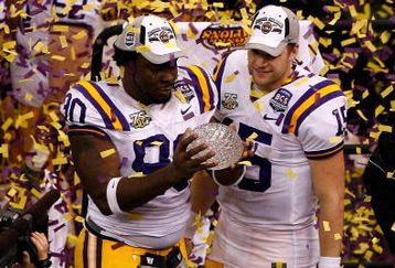NEW ORLEANS - JANUARY 07:  Ricky Jean-Francois #90 and Matt Flynn #15 of the Louisiana State University Tigers celebrate with the championship trophy after defeating the Ohio State Buckeyes 38-24 in the AllState BCS National Championship on January 7, 2008 at the Louisiana Superdome in New Orleans, Louisiana.  (Photo by Christian Petersen/Getty Images)