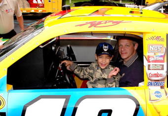 HACKETTSTOWN, NJ - JUNE 04: A young fan and his father enjoy the #18 car during Mars Employee Appreciation Day at Mars Headquarters on June 4, 2009 in Hackettstown, New Jersey.  (Photo by Andy Marlin/Getty Images for Mars)