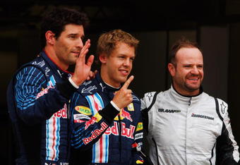 NORTHAMPTON, UNITED KINGDOM - JUNE 20:  Pole sitter Sebastian Vettel (C) of Germany and Red Bull Racing celebrates with second placed Rubens Barrichello (R) of Brazil and Brawn GP and third placed Mark Webber (L) of Australia and Red Bull Racing following qualifying for the British Formula One Grand Prix at Silverstone on June 20, 2009 in Northampton, England.  (Photo by Mark Thompson/Getty Images)