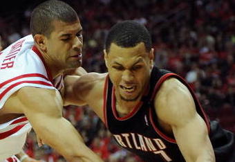 HOUSTON - APRIL 24:  Guard Brandon Roy #7 of the Portland Trail Blazers dribbles the ball past Shane Battier #31 of the Houston Rockets in Game Three of the Western Conference Quarterfinals during the 2009 NBA Playoffs at Toyota Center on April 24, 2009 in Houston, Texas. NOTE TO USER: User expressly acknowledges and agrees that, by downloading and or using this photograph, User is consenting to the terms and conditions of the Getty Images License Agreement.  (Photo by Ronald Martinez/Getty Images)