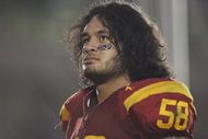 PASADENA, CA - DECEMBER 6:  Rey Maualuga #58 of the USC Trojans reflects after celebrating with the band and fans following the victory against the UCLA Bruins on December 6, 2008 at the Rose Bowl in Pasadena, California.  USC won 28-7.  (Photo by Jeff Golden/Getty Images)