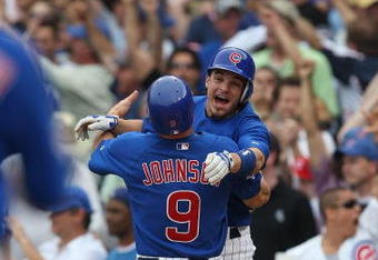CHICAGO - JUNE 18: Ryan Theriot #2 of the Chicago Cubs hugs teammate Reed Johnson #9 after Johnson scored the winning run in the bottom of the 9th inning on a single by Alfonso Soriano to beat the Chicago White Sox on June 18, 2009 at Wrigley Field in Chicago, Illinois. The Cubs defeated the White Sox 6-5. (Photo by Jonathan Daniel/Getty Images)