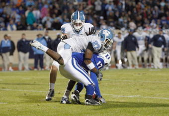 DURHAM, NC - NOVEMBER 29:  Sheldon Bell #17 of the Duke Blue Devils is tackled by Deunta Williams #27 and Chase Rice #44 of the North Carolina Tar Heels at Wallace Wade Stadium on November 29, 2008 in Durham, North Carolina. (Photo by Kevin C. Cox/Getty Images)