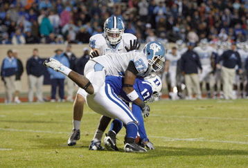 DURHAM, NC - NOVEMBER 29:  Sheldon Bell #17 of the Duke Blue Devils is tackled by Deunta Williams #27 and Chase Rice #44 of the North Carolina Tar Heels at Wallace Wade Stadium on November 29, 2008 in Durham, North Carolina. (Photo by Kevin C. Cox/Getty Images)