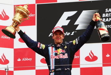 NORTHAMPTON, UNITED KINGDOM - JUNE 21:  Sebastian Vettel of Germany and Red Bull Racing celebrates on the podium after winning the British Formula One Grand Prix at Silverstone on June 21, 2009 in Northampton, England.  (Photo by Clive Mason/Getty Images)