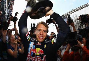 NORTHAMPTON, UNITED KINGDOM - JUNE 21:  Sebastian Vettel of Germany and Red Bull Racing celebrates with team mates in the paddock after winning the British Formula One Grand Prix at Silverstone on June 21, 2009 in Northampton, England.  (Photo by Paul Gilham/Getty Images)