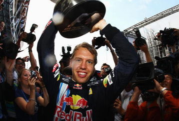 NORTHAMPTON, UNITED KINGDOM - JUNE 21:  Sebastian Vettel of Germany and Red Bull Racing celebrates with team mates in the paddock after winning the British Formula One Grand Prix at Silverstone on June 21, 2009 in Northampton, England.  (Photo by Paul Gilham/Getty Images)