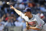 KANSAS CITY, MO - APRIL 15:  Kerry Wood of the Cleveland Indians, wearing a #42 jersey during the Jackie Robinson Day game throws a pitch in the ninth inning against the Kansas City Royals on April 15, 2009 at Kauffman Stadium in Kansas City, Missouri.  (Photo by G. Newman Lowrance/Getty Images)