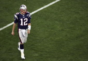 GLENDALE, AZ - FEBRUARY 03:  Tom Brady #12 of the New England Patriots walks off the field against the New York Giants in Super Bowl XLII on February 3, 2008 at the University of Phoenix Stadium in Glendale, Arizona.  (Photo by Jim McIsaac/Getty Images)