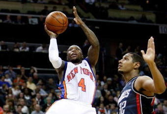 CHARLOTTE, NC - MARCH 28:  Boris Diaw #32 of the Charlotte Bobcats watches as Nate Robinson #4 of the New York Knicks goes to the basket during their game at Time Warner Cable Arena on March 28, 2009 in Charlotte, North Carolina.  NOTE TO USER: User expressly acknowledges and agrees that, by downloading and/or using this Photograph, user is consenting to the terms and conditions of the Getty Images License Agreement.  (Photo by Streeter Lecka/Getty Images)