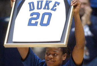 DURHAM, NC - JANUARY 24:  Duke's Alana Beard raises up her framed jersey number after an official ceremony retiring her jersey before the game against Tennessee in Cameron Indoor Stadium January 24, 2004 in Durham, North Carolina. Beard is the first woman basketball player in Duke history to have her jersey retired. She is a two-time Kodak All-American and 2003 National Player of the Year. She is the career point's leader at Duke with 2,320. . (Photo by Sara D. Davis/Getty Images)