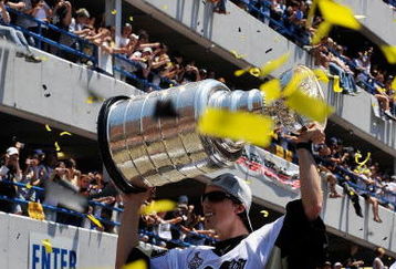 PITTSBURGH - JUNE 15:  Marc-Andre Fleury #29 of the Pittsburgh Penguins holds aloft the Stanley Cup for the crowd on the Blvd of the Allies during Stanley Cup Champion Victory Parade on June 15, 2009 in Pittsburgh, Pennsylvania.  (Photo by Jamie Sabau/Getty Images)