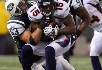 EAST RUTHERFORD, NJ - NOVEMBER 30:  Brandon Marshall #15 of the Denver Broncos is tackled by Cody Spencer #53 of the New York Jets on November 30, 2008 at Giants Stadium in East Rutherford, New Jersey. The Broncos defeated the Jets 34-17.  (Photo by Jim McIsaac/Getty Images)
