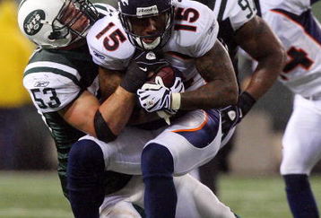 EAST RUTHERFORD, NJ - NOVEMBER 30:  Brandon Marshall #15 of the Denver Broncos is tackled by Cody Spencer #53 of the New York Jets on November 30, 2008 at Giants Stadium in East Rutherford, New Jersey. The Broncos defeated the Jets 34-17.  (Photo by Jim McIsaac/Getty Images)